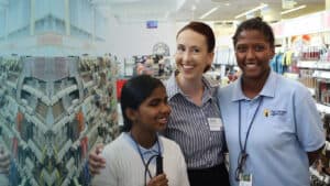 two First Jobs participants pose for a photo with a Walgreens employee