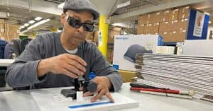 A man who is blind assembles a Kensington product in Chicago Lighthouse Industries