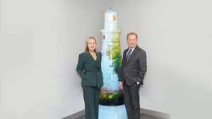 Janet Szlyk and Tom Deutsch pose for a photo in front of a lighthouse sculpture