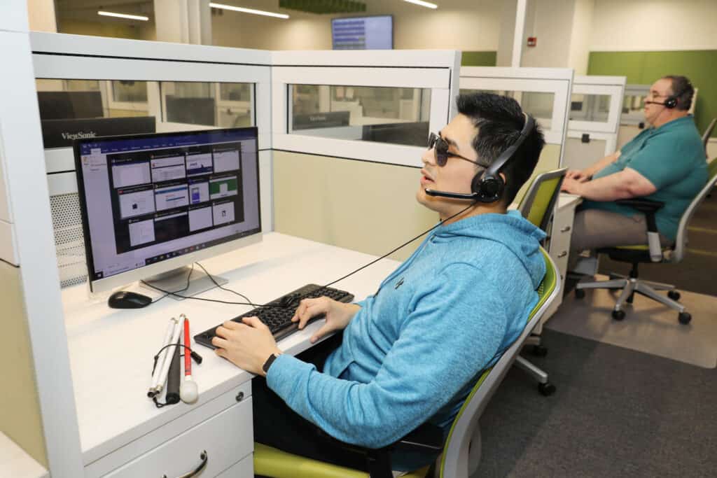 A call center agent who is blind takes a call