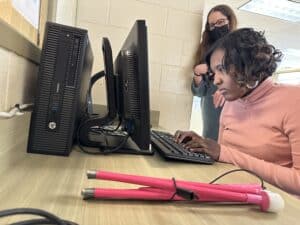 A woman who is blind receives computer training
