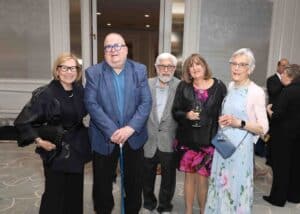 Five adults posing for a photo at our Seeing What's Possible Annual Gala. They are wearing formal attire and smiling.