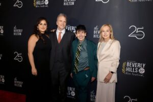 Kamyla, Tim, Dom, and Dr. Szlyk posing together at the Beverly Hills Film Festival, with a backdrop featuring the event and sponsor logos.