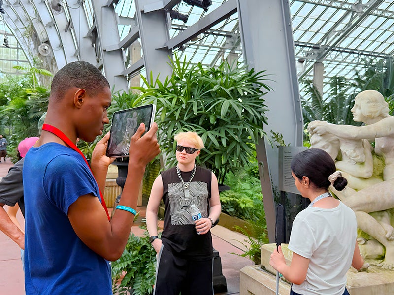 3 blind youth transitions students take photos with an ipad at a garden