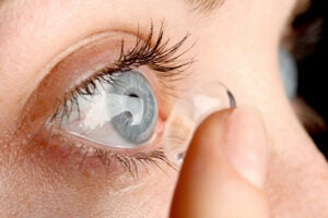 A woman putting in a contact lenses