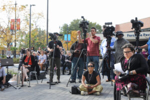 a crew of cameramen cover the ribbon cutting at the Foglia Residences grand opening.